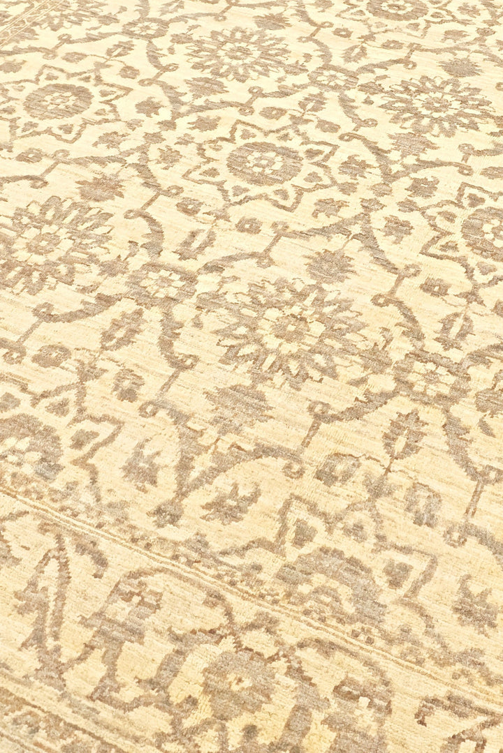 Close-up of a patterned rug with intricate designs on a beige background