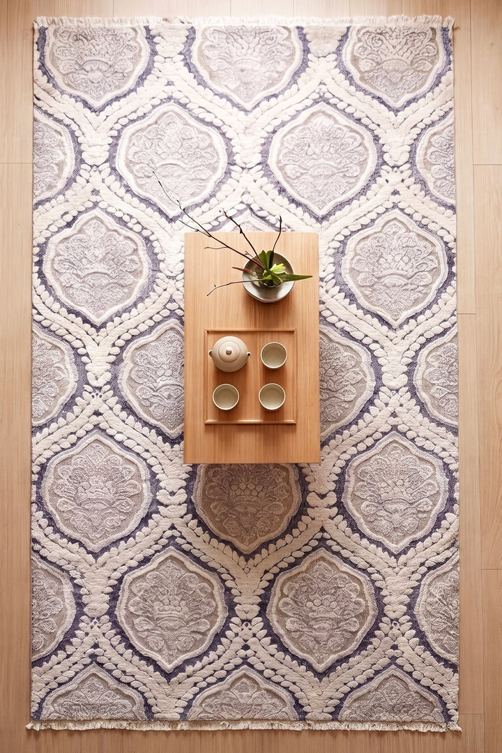 Decorative rug with geometric pattern on a wooden floor