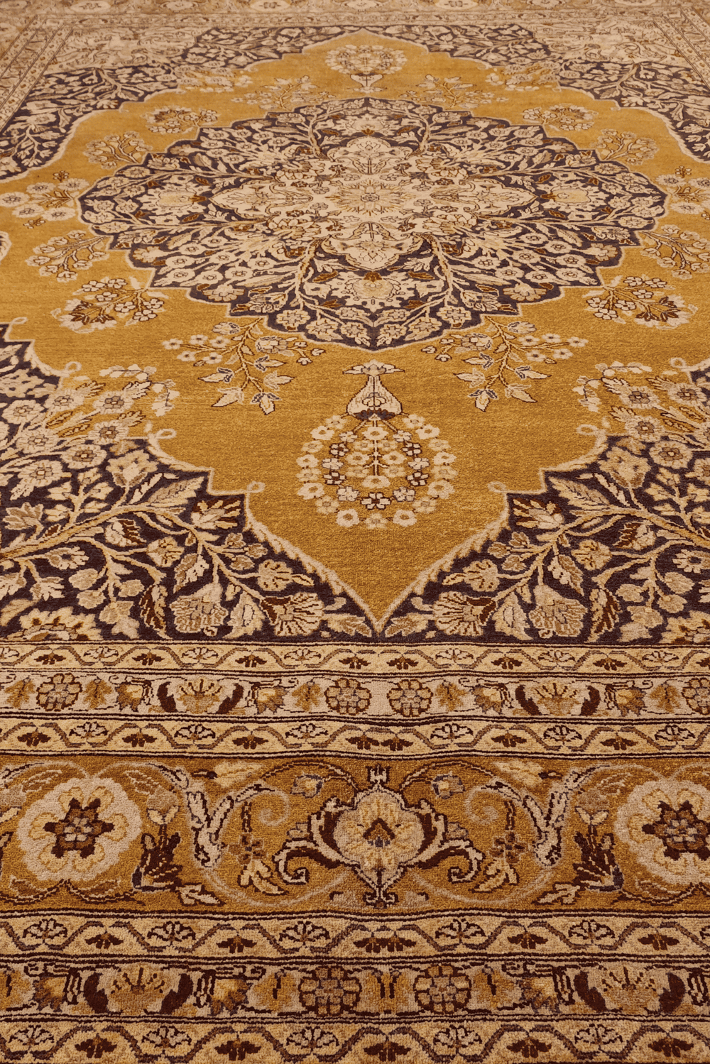 Medallion detail in amber and mahogany on Chobi rug