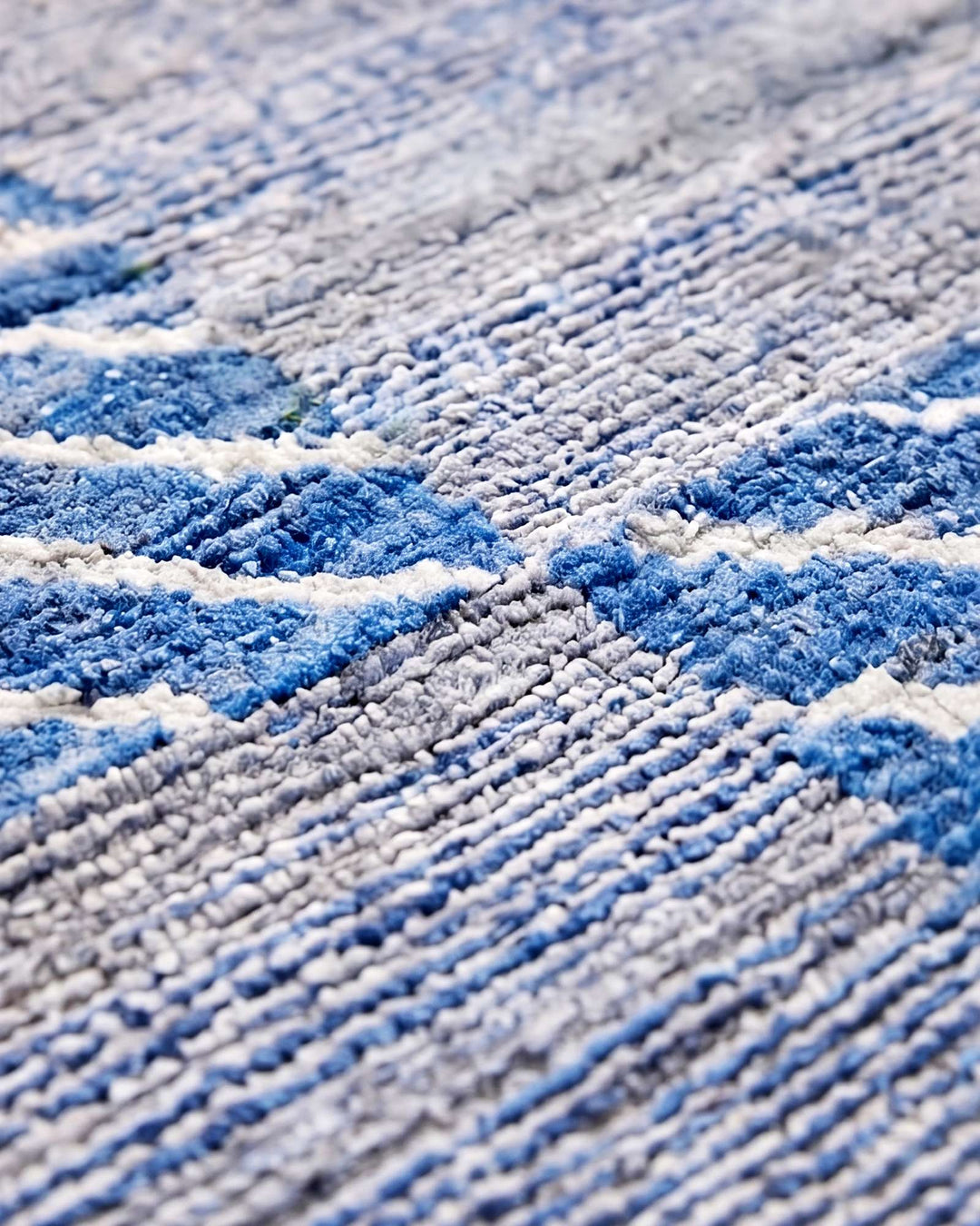 Corner of blue check Afghan Gabbeh wool rug