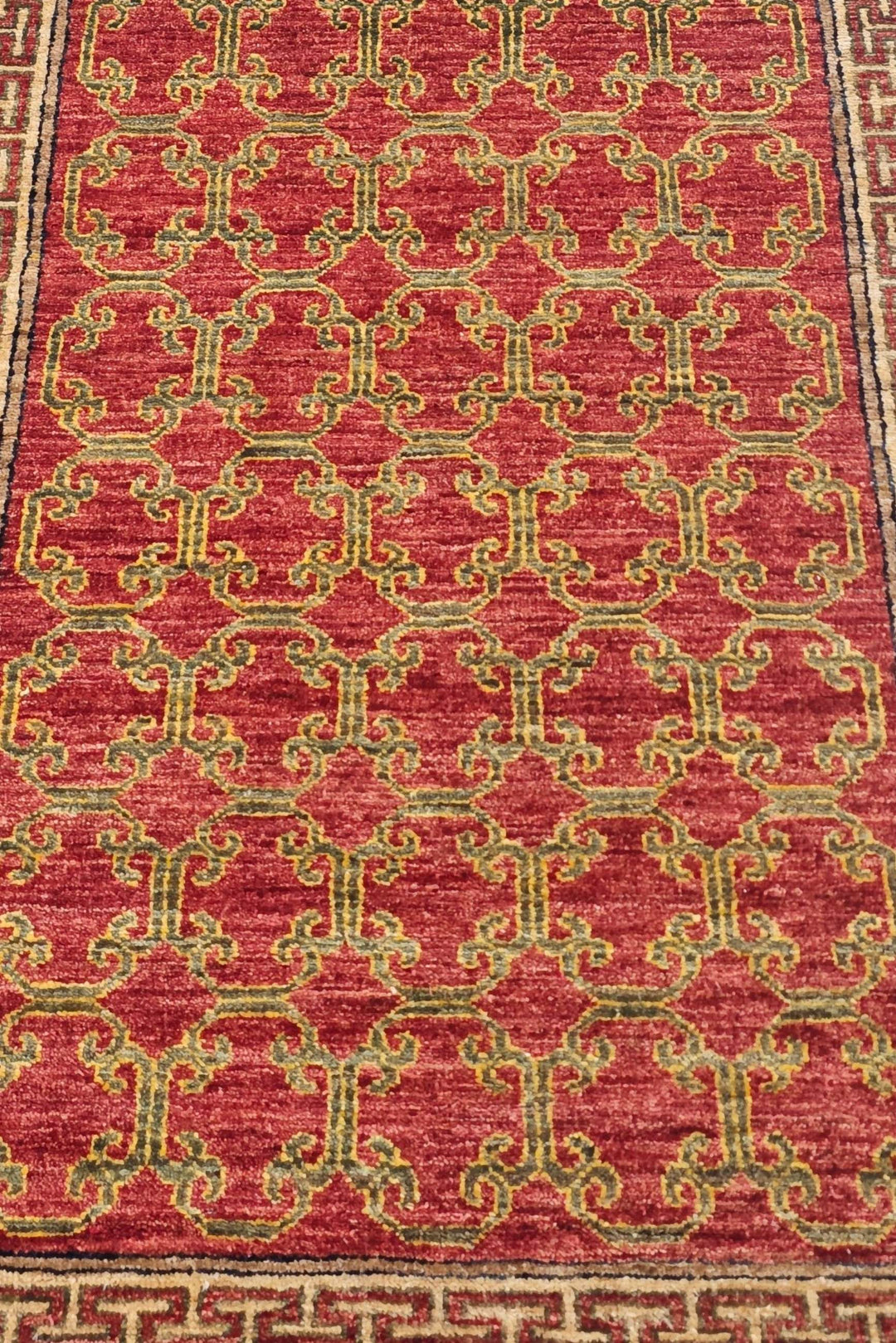 Hand-knotted brick red Afghan runner with camel meander border