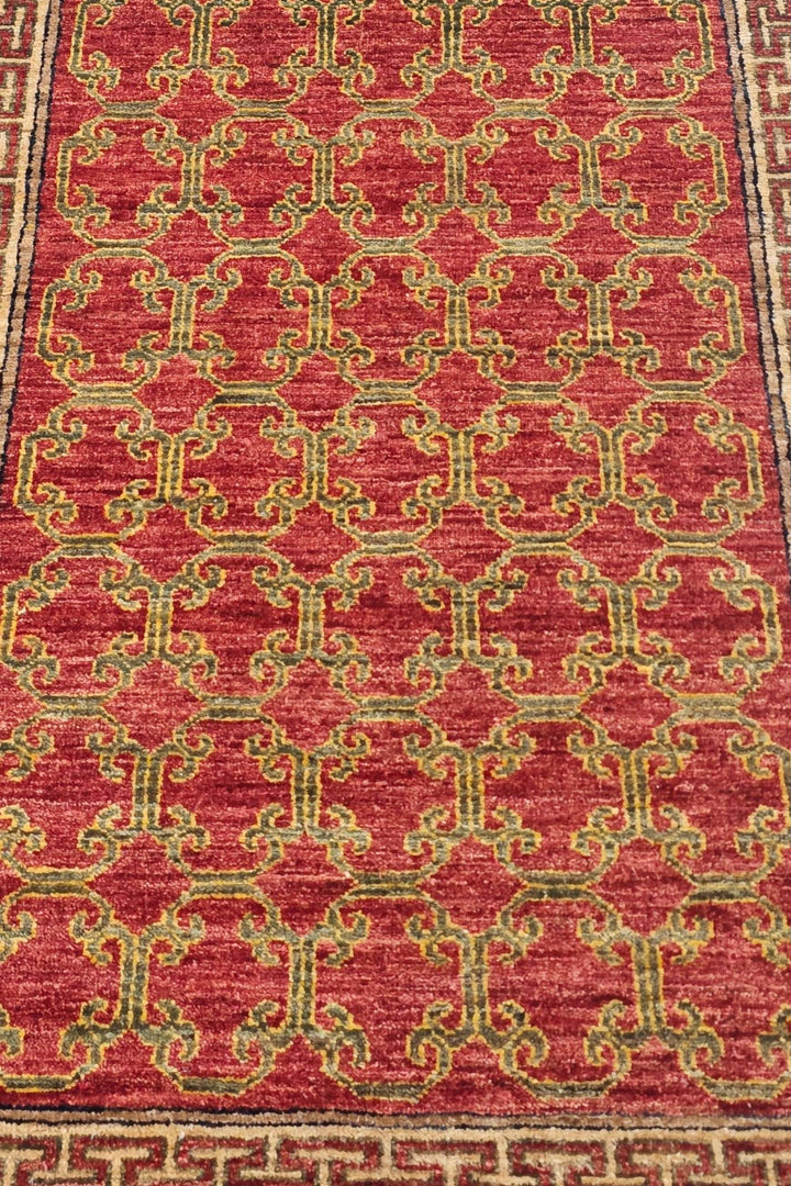 Hand-knotted brick red Afghan runner with camel meander border