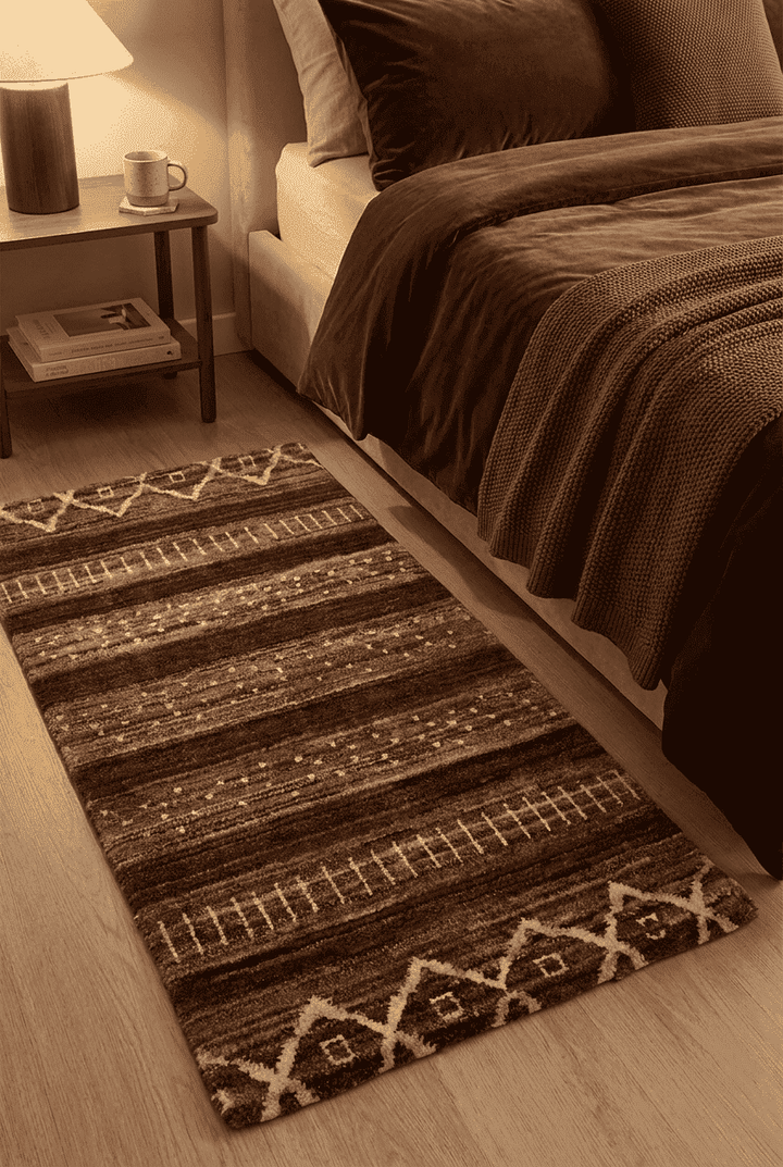 Tribal diamond motifs in brown on Afghan Gabbeh wool rug