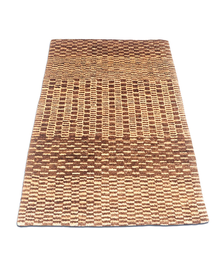 Border detail of brown checkerboard hand-knotted Gabbeh rug