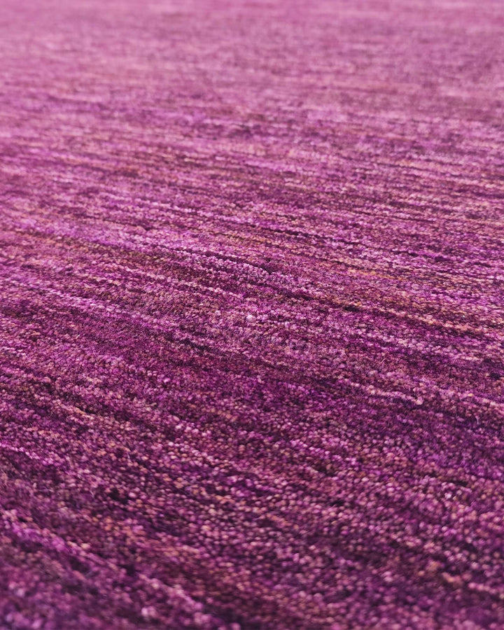 Border detail of mulberry purple hand-knotted Afghan Gabbeh rug