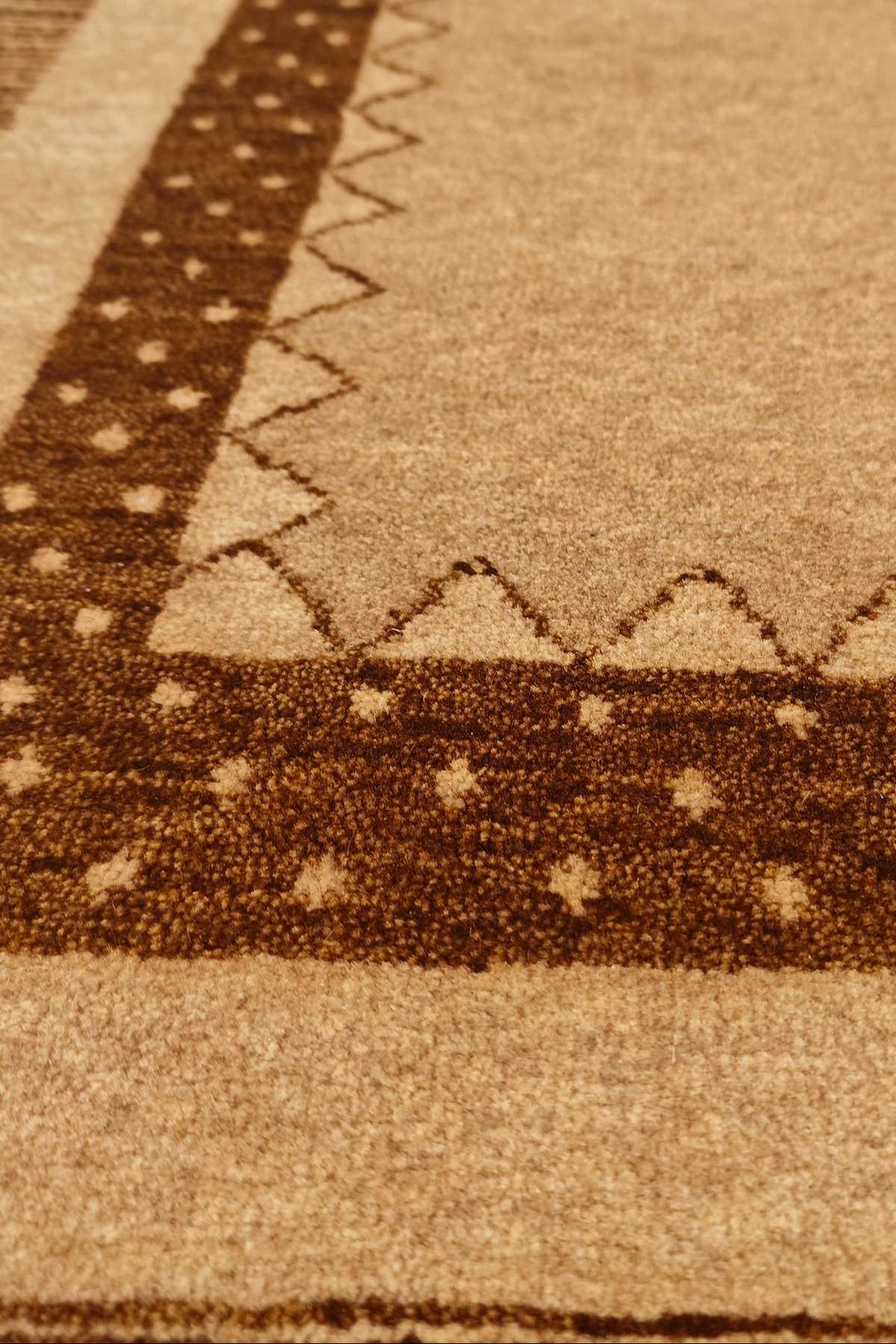 Border detail of camel brown hand-knotted Afghan Gabbeh rug
