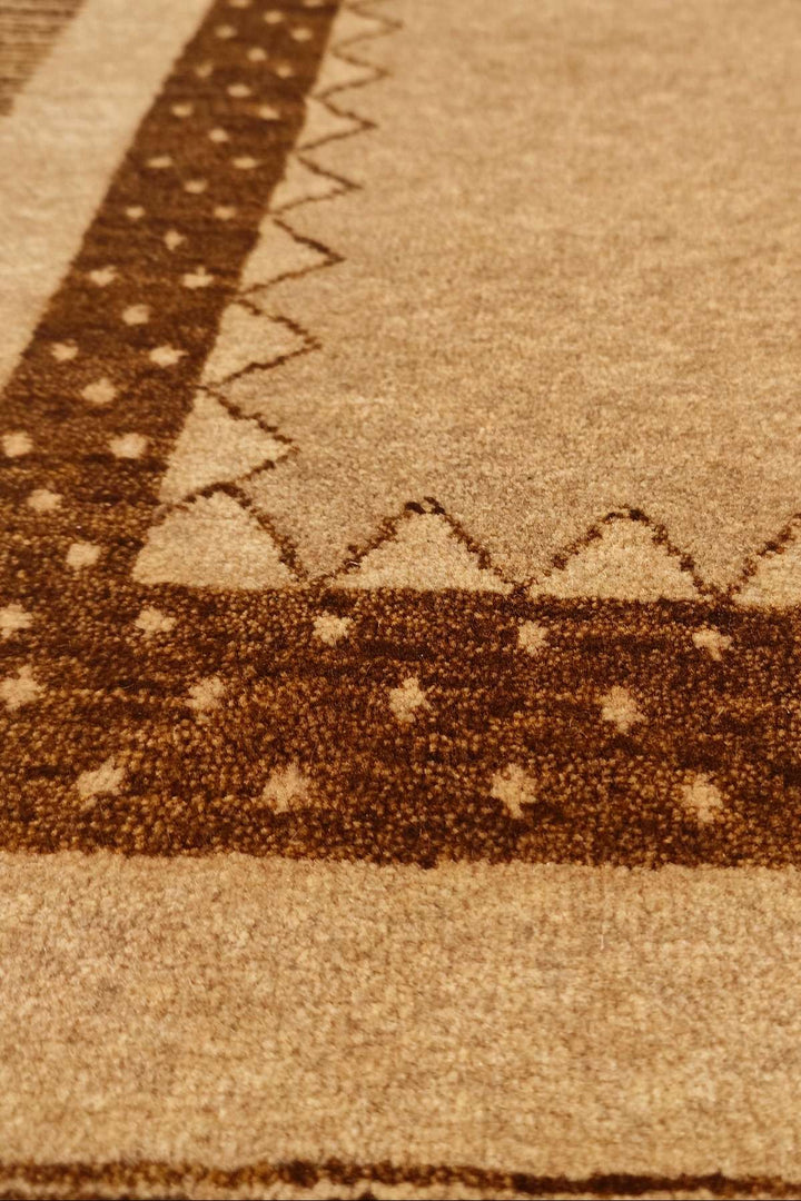 Border detail of camel brown hand-knotted Afghan Gabbeh rug