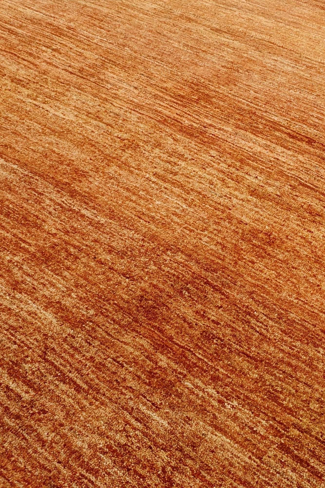 Modern field of hand-knotted amber gold Ghazni rug