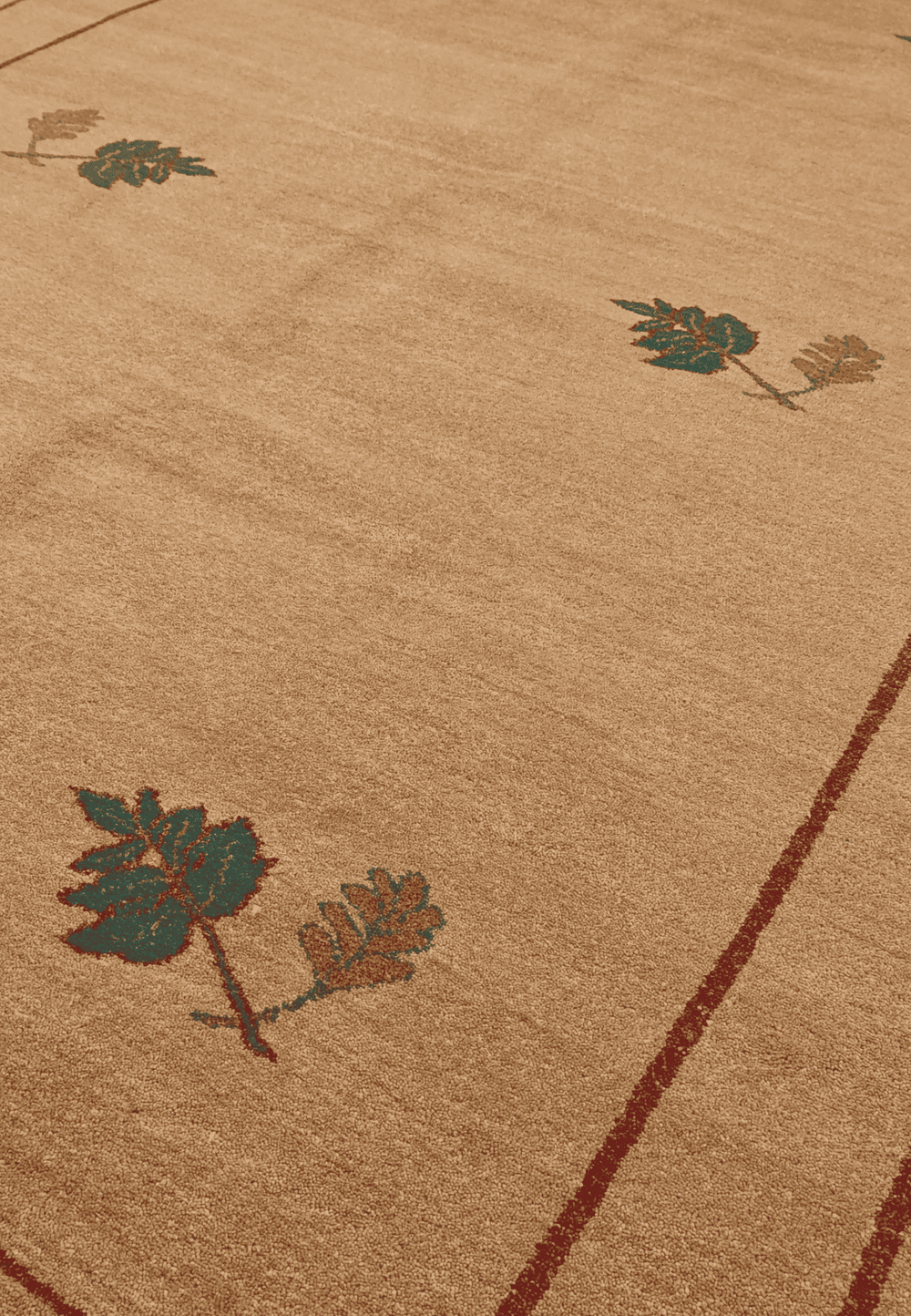 Floral sprig detail in camel and green on Ghazni rug