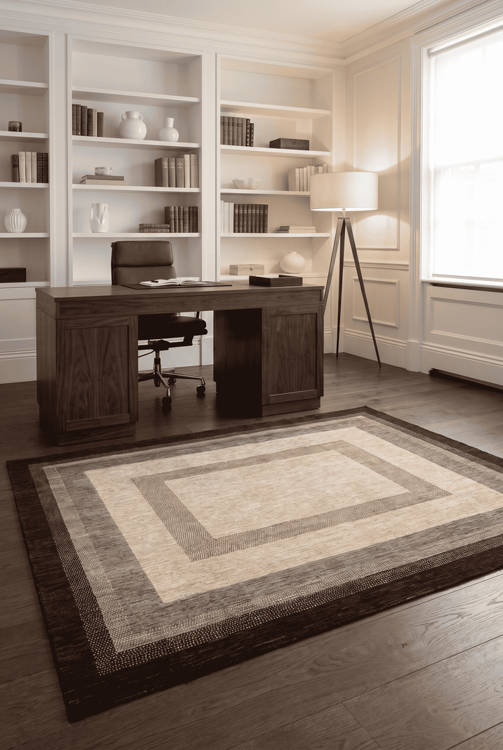 Graduated border detail in cream and brown on Ghazni rug