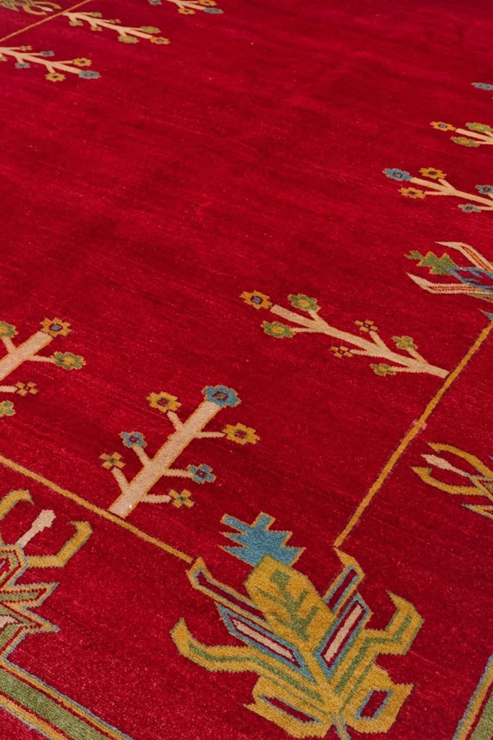 Flowering tree detail in deep red and cream on Ghazni rug