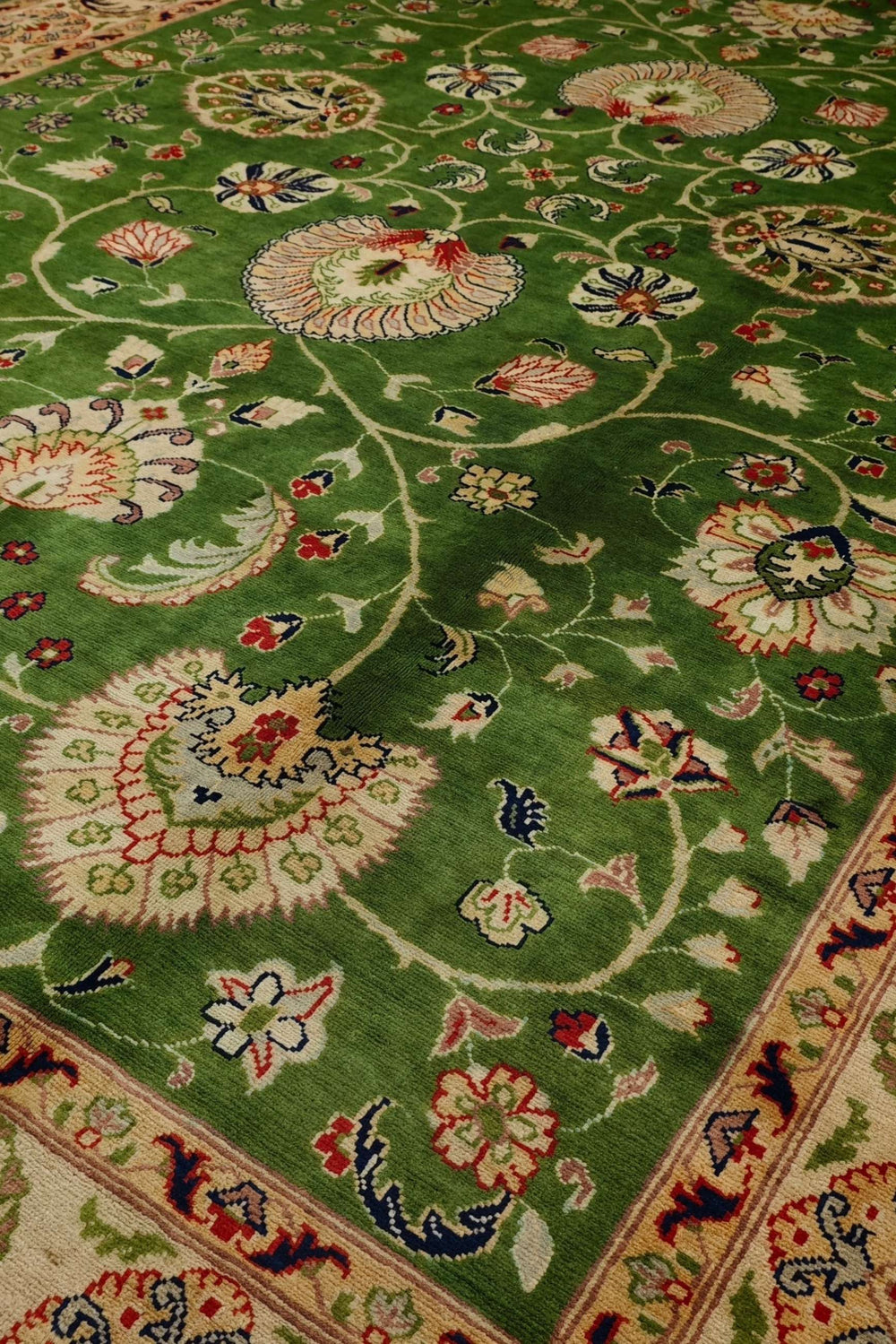 Floral detail in green on Afghan Ghazni wool rug