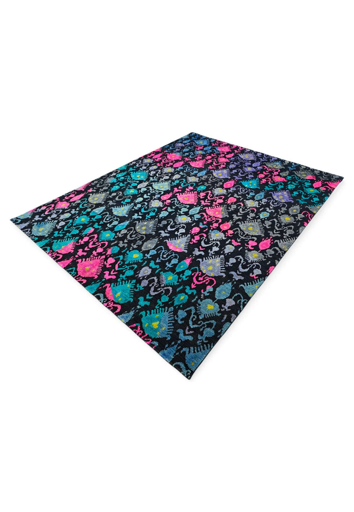 Hand-knotted wool pile of indigo magenta ikat Ghazni rug