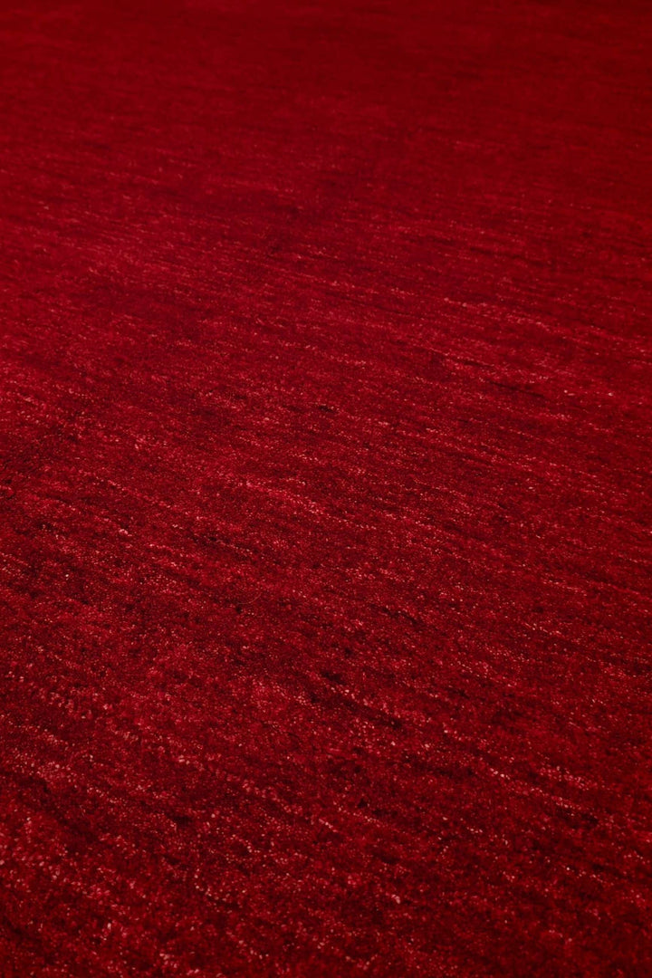 Plain field detail in madder red on Afghan Ghazni rug