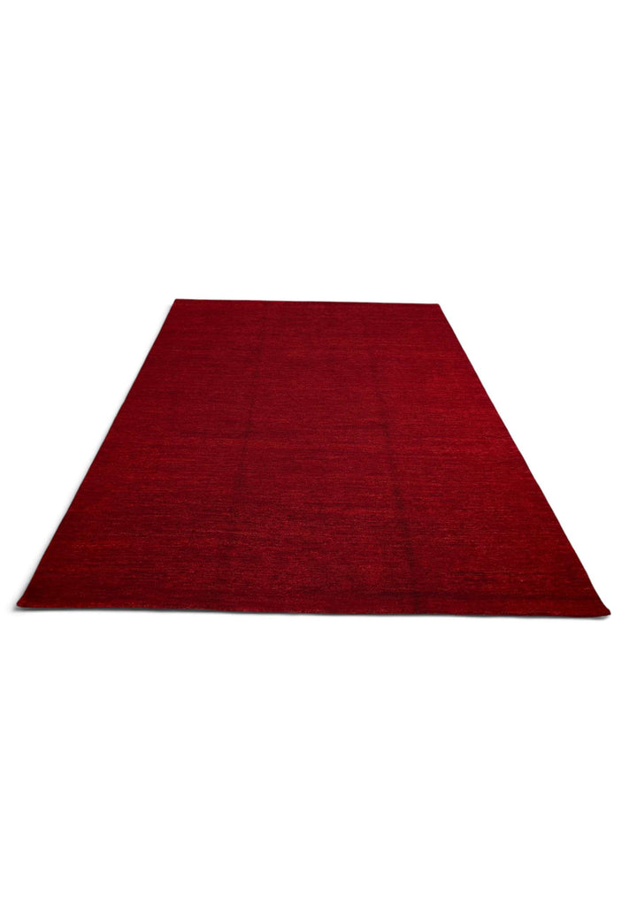 Border detail of madder red Ghazni hand-knotted rug