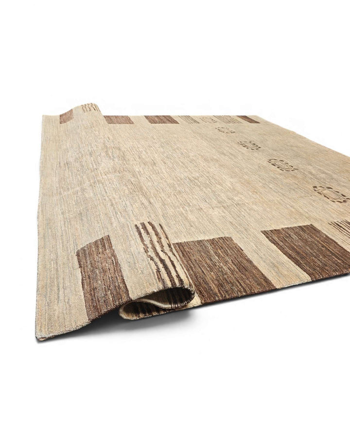 Hand-knotted natural Ghazni rug with quiet tribal border