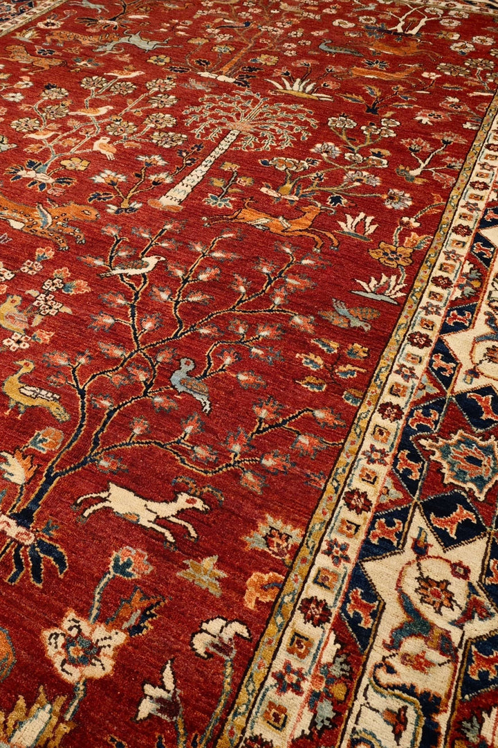 Shikargah hunting scene detail with animals on red Ghazni rug