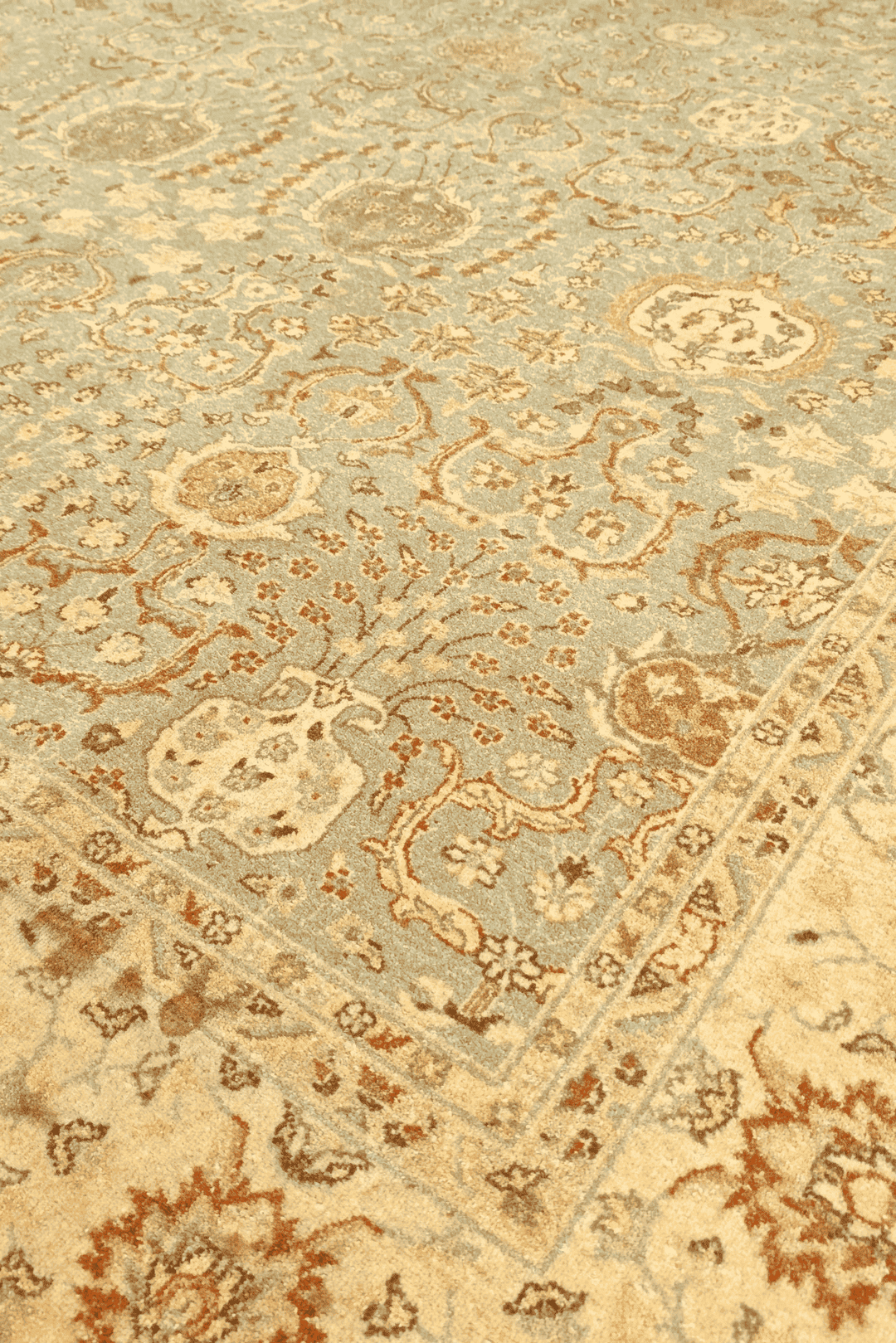 All-over floral detail in pale sage and gold on Ghazni rug