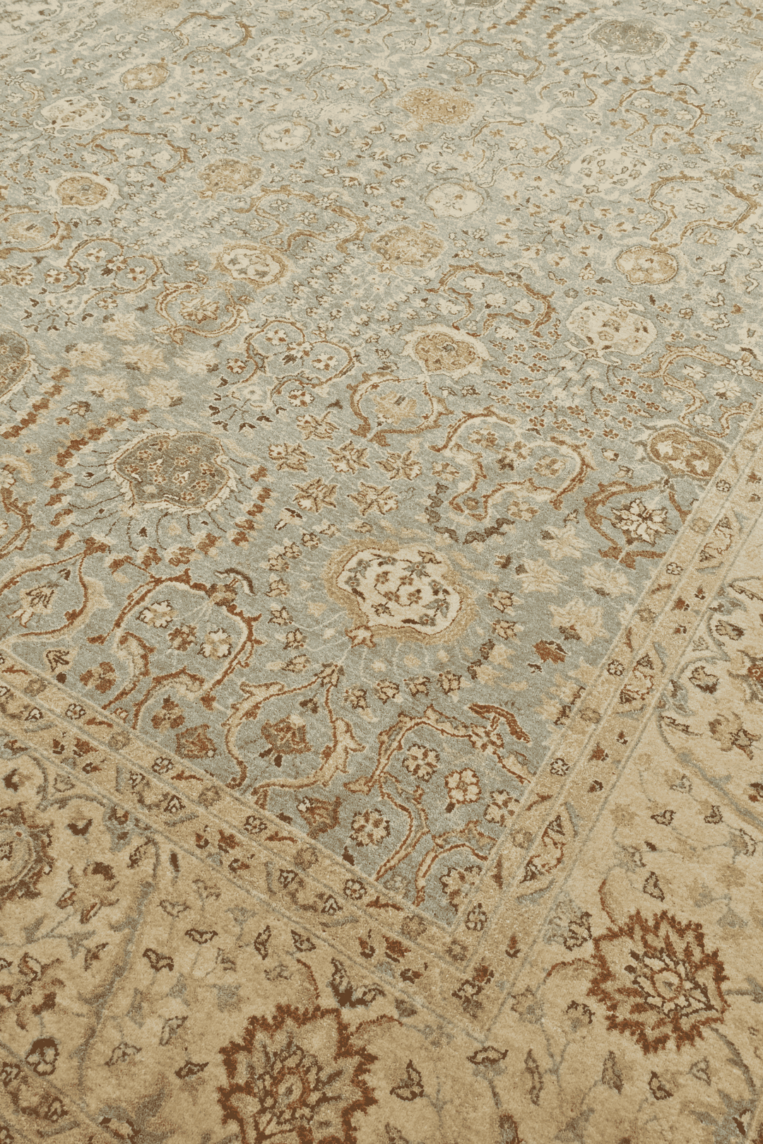 Floral detail in pale sage and sandstone on Ghazni rug