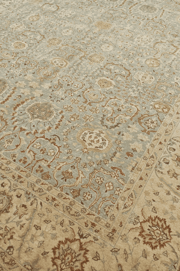 Floral detail in pale sage and sandstone on Ghazni rug