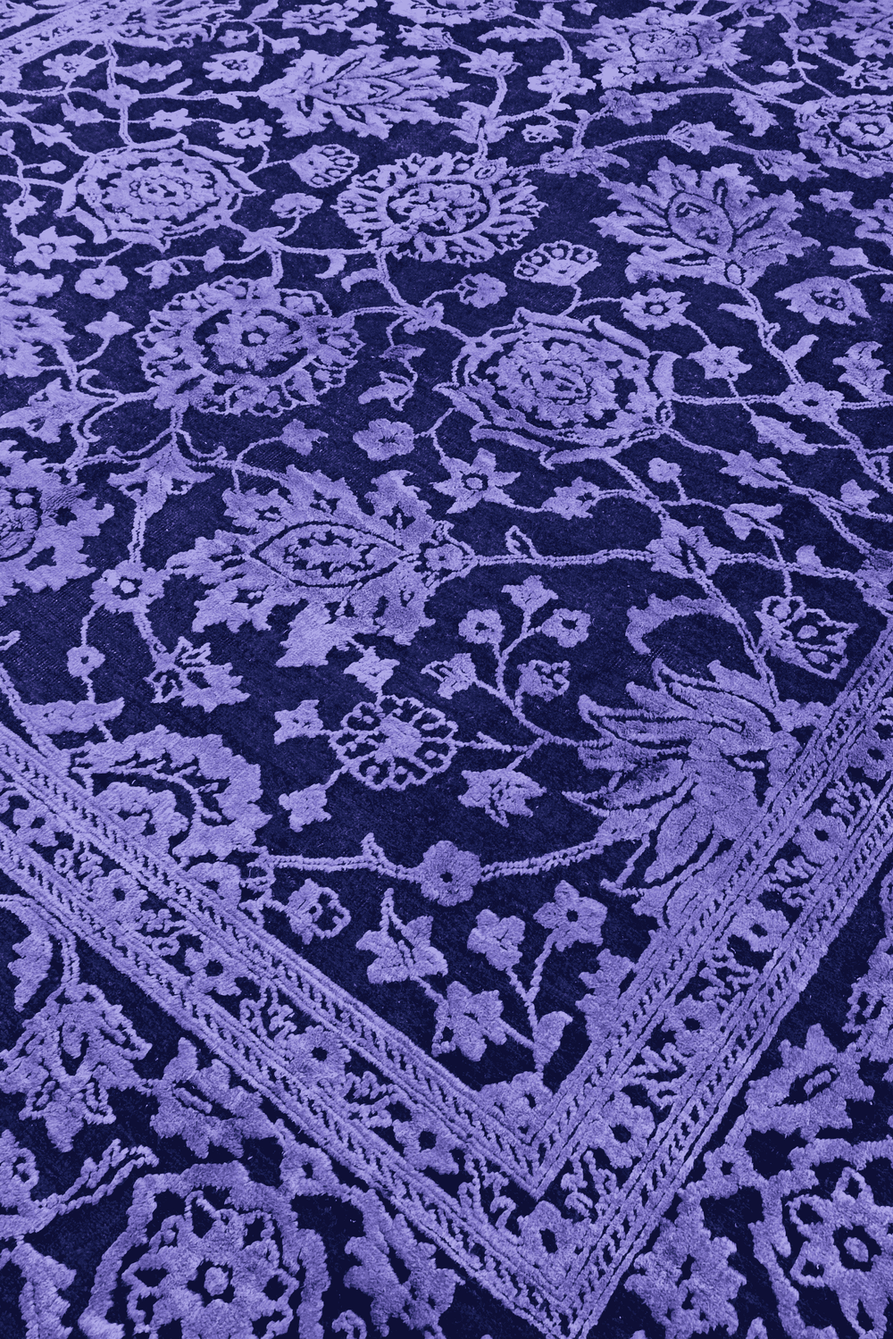 Overdyed floral detail in violet on Afghan Ghazni rug