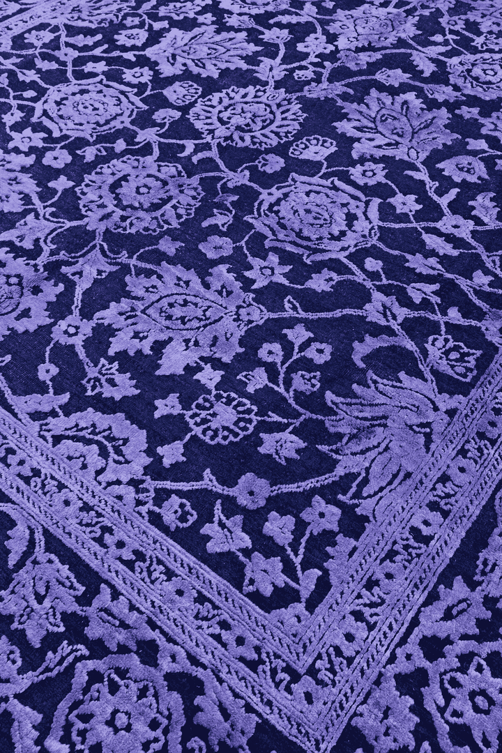 Overdyed floral detail in violet on Afghan Ghazni rug