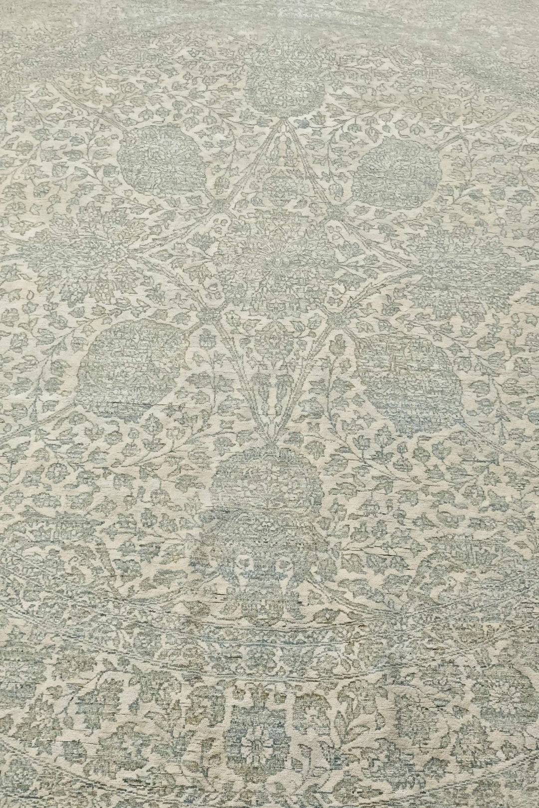Concentric floral detail in sage and cream on round rug