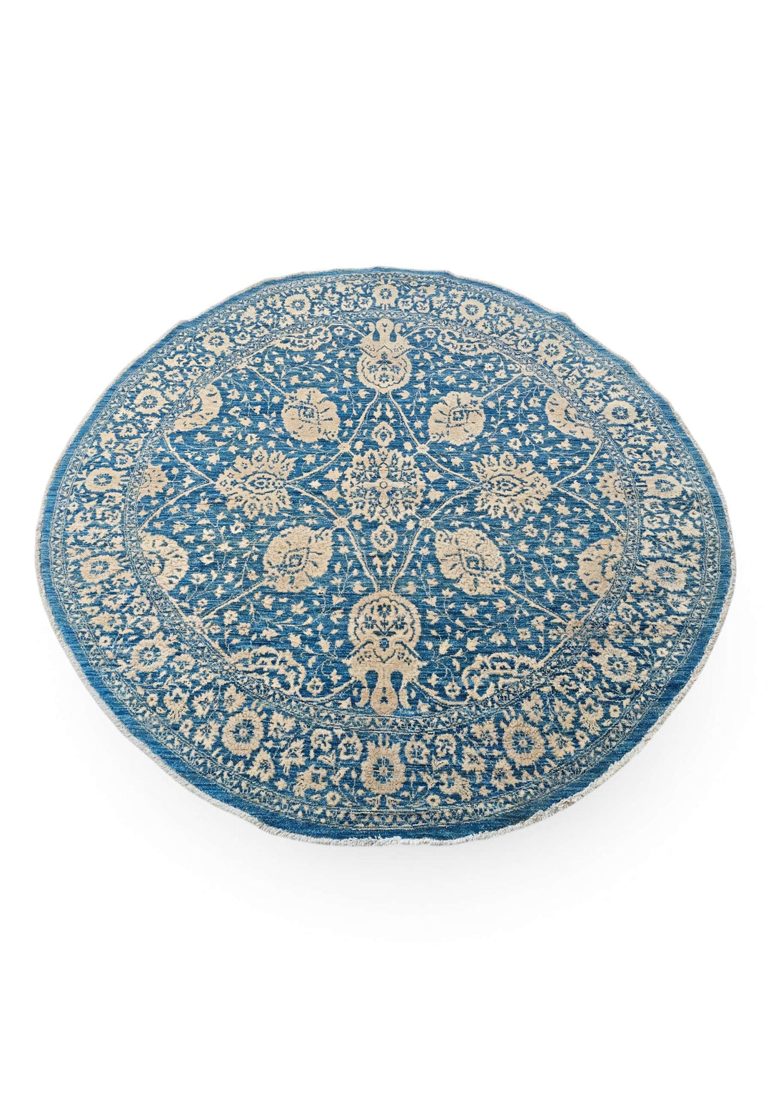 Circular edge of slate blue round Ghazni hand-knotted rug