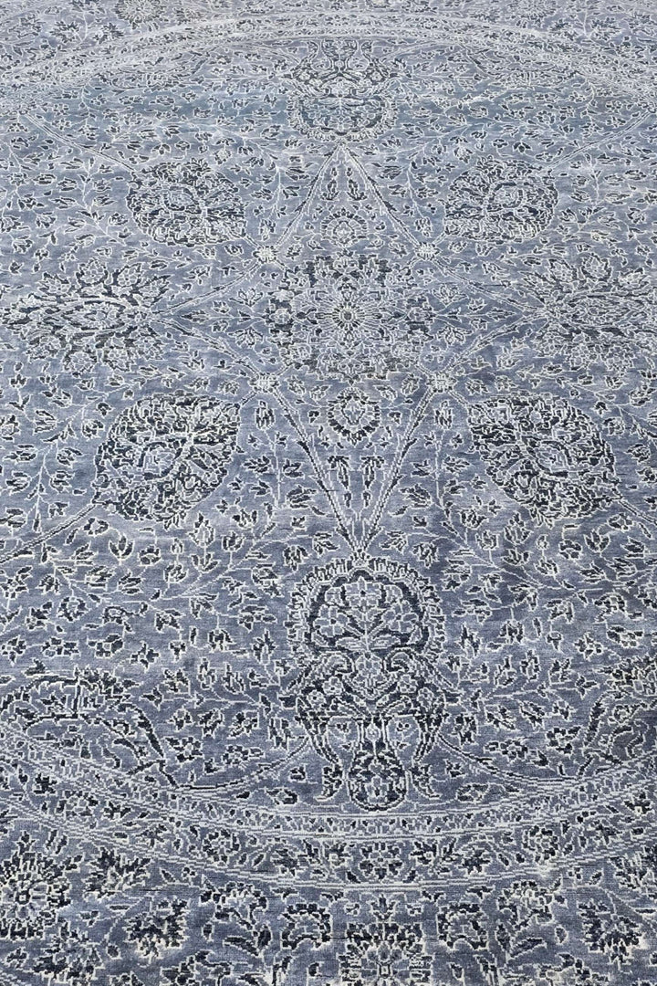 All-over floral detail in slate blue and silver on round rug