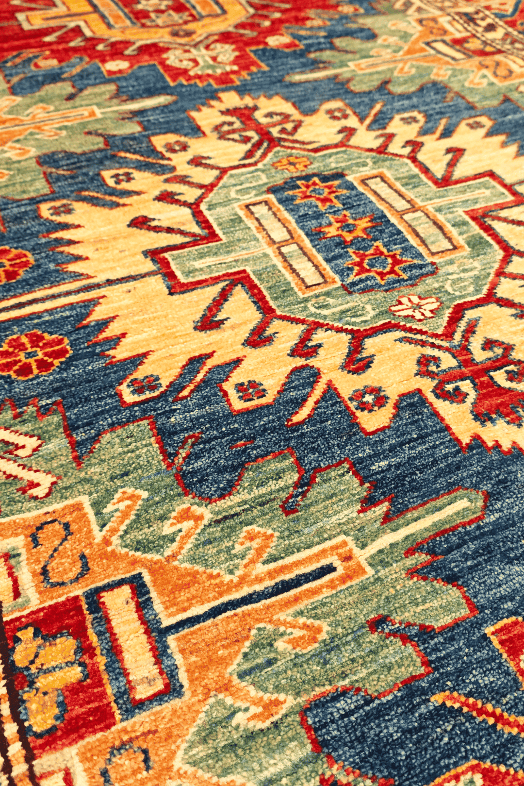 Border detail of blue red medallion Kazak rug