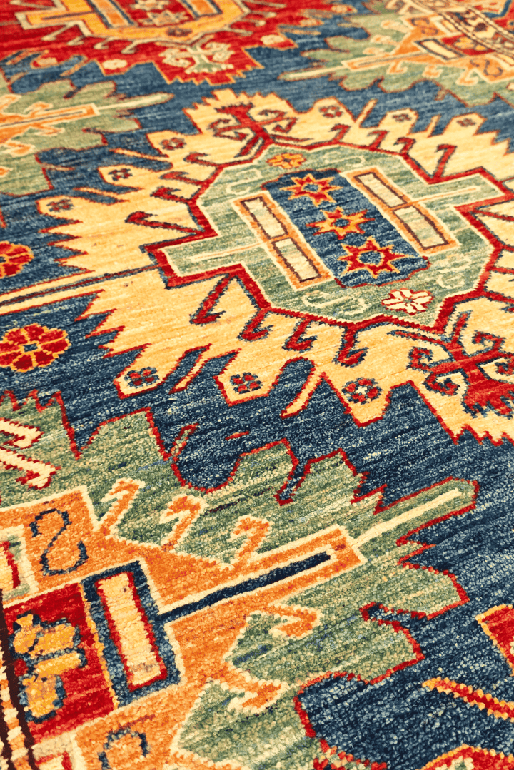 Border detail of blue red medallion Kazak rug