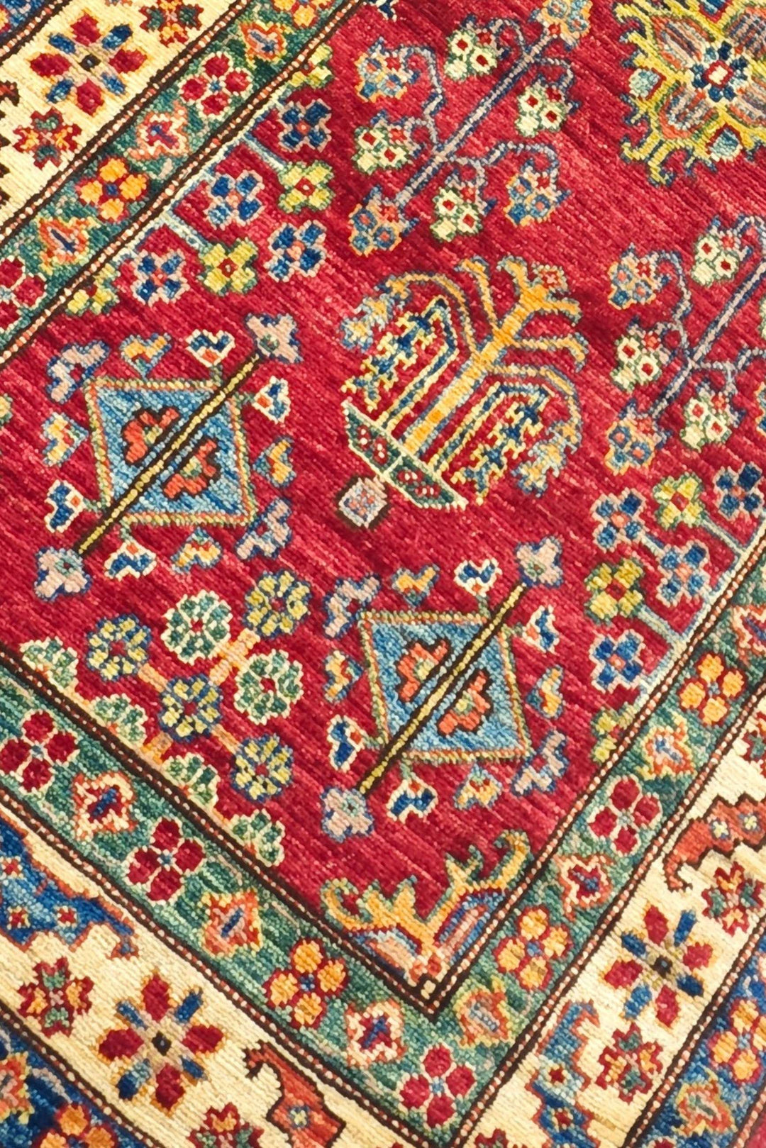 All-over floral detail in red and ivory on Kazak runner