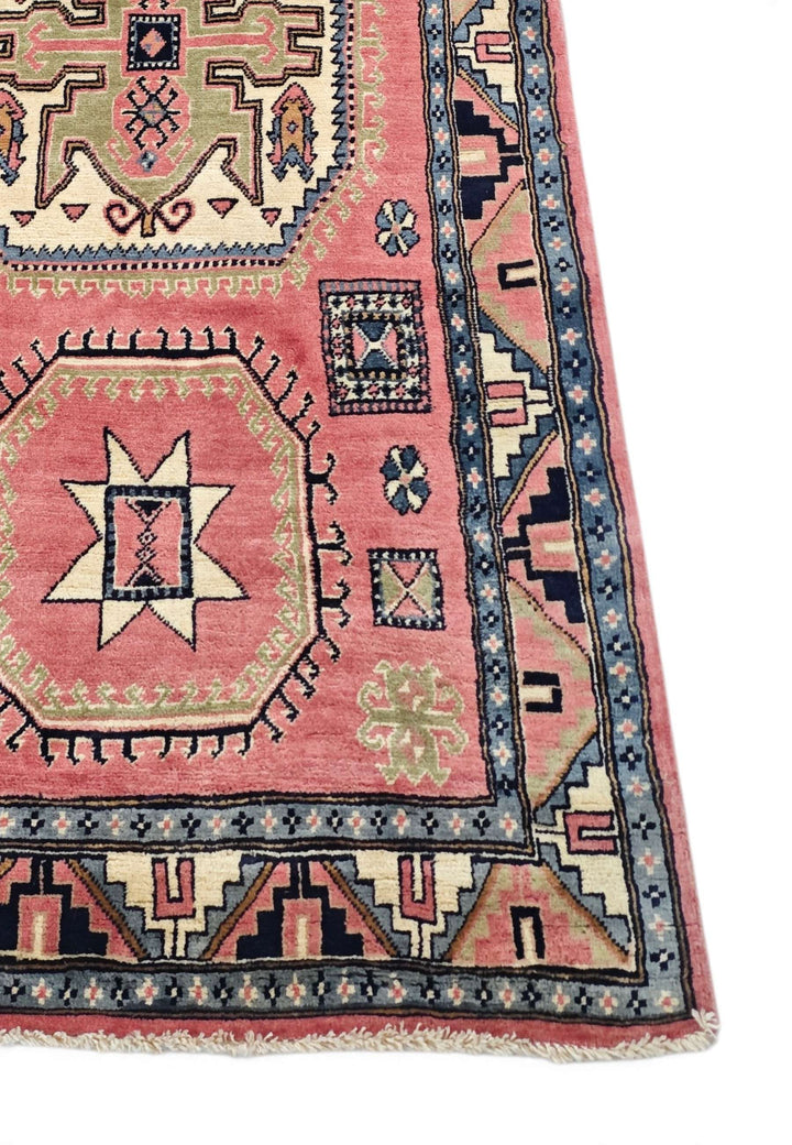 Corner of rose ivory Kazak hand-knotted rug