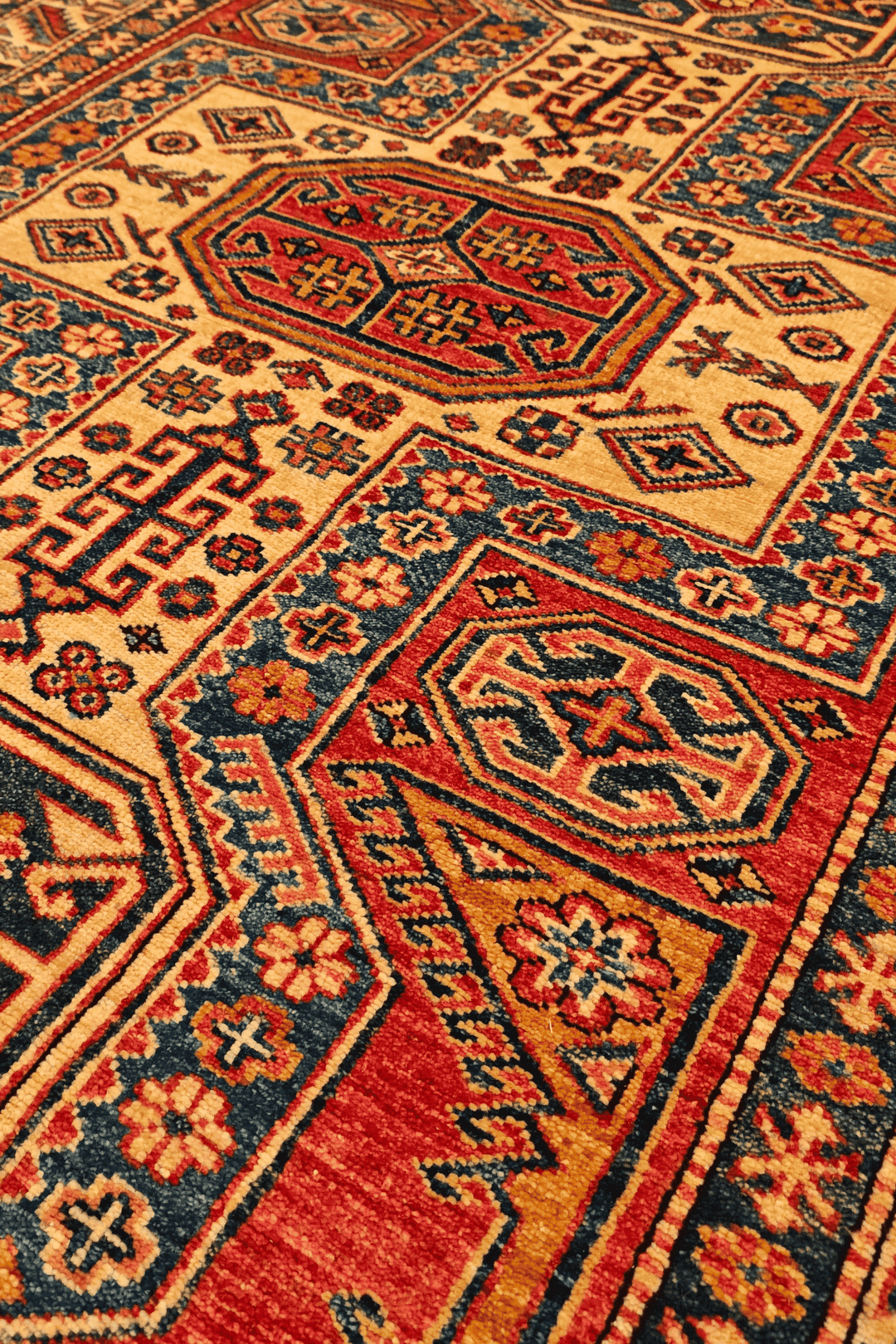 Hand-knotted wool pile of red gold Kazak rug, 127×178cm