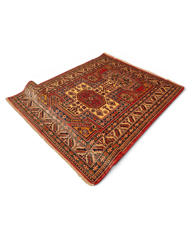Corner of red gold octagon Kazak rug