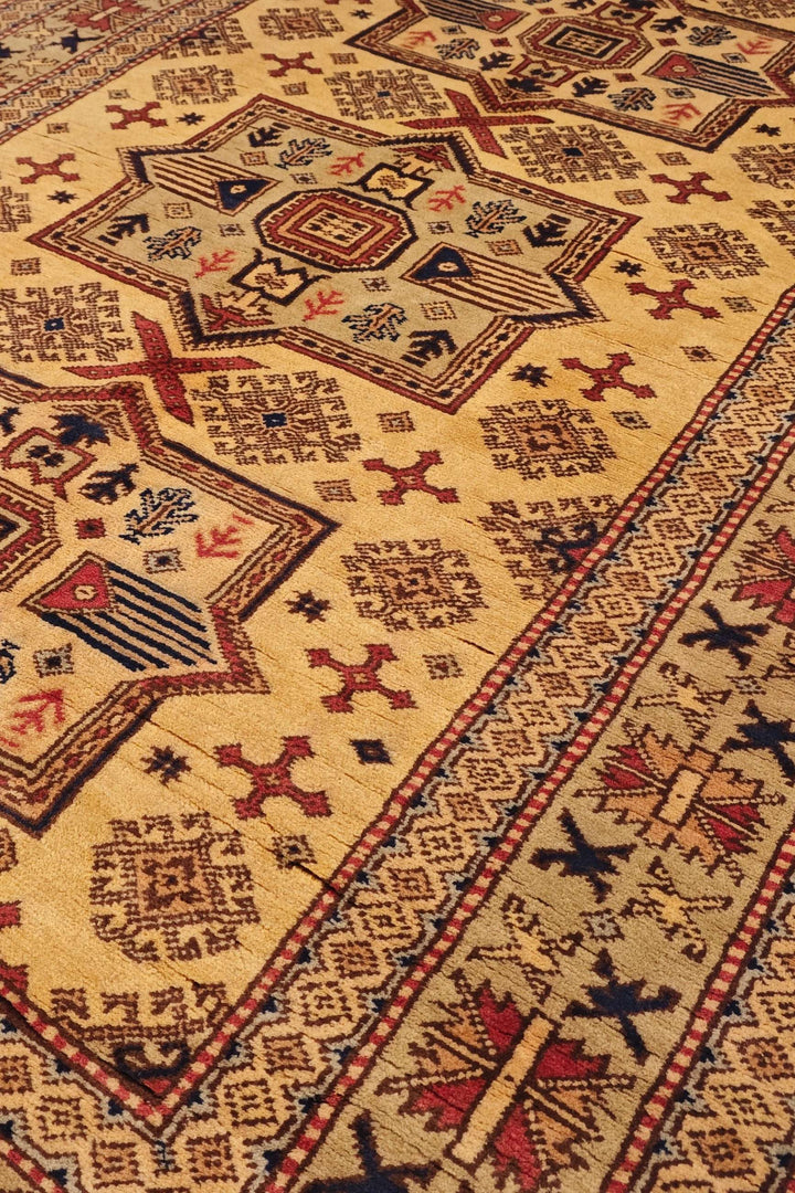 Caucasian star detail in gold on Kazak rug