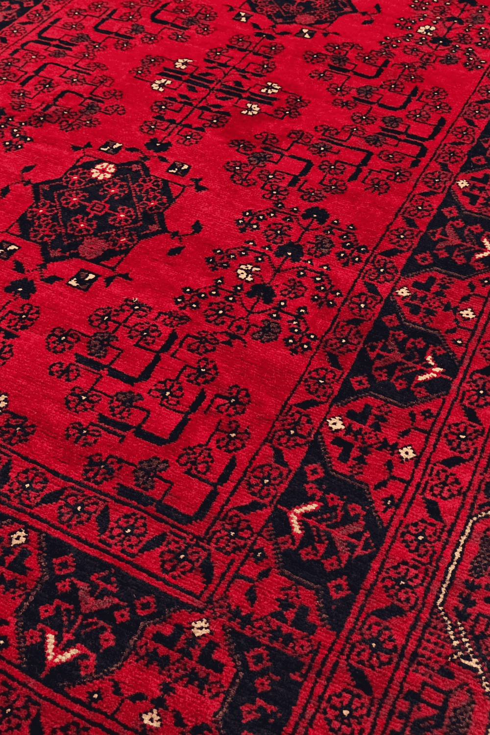 Pattern detail in bright red and navy on Khal Mohammadi runner