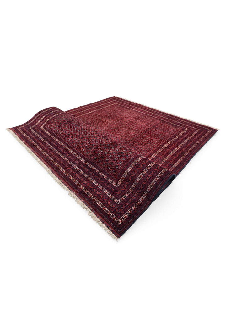 Hand-knotted burgundy Roshnai rug with Turkmen güls