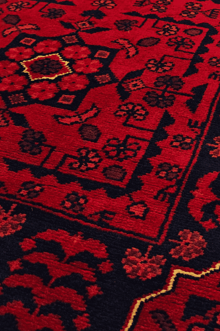 Pattern detail in cherry red and navy on Khal Mohammadi runner