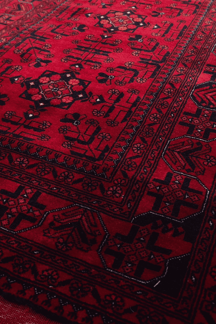 Diamond medallion detail in deep red on Khal Mohammadi rug