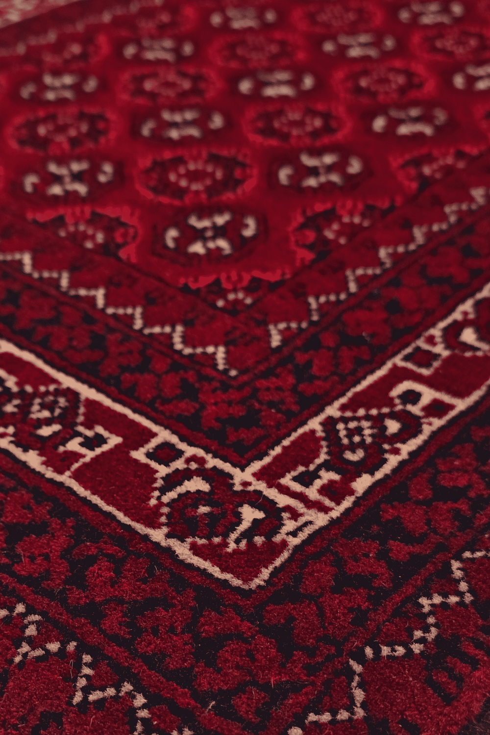 Turkmen gül detail in deep red on small Khal Mohammadi rug