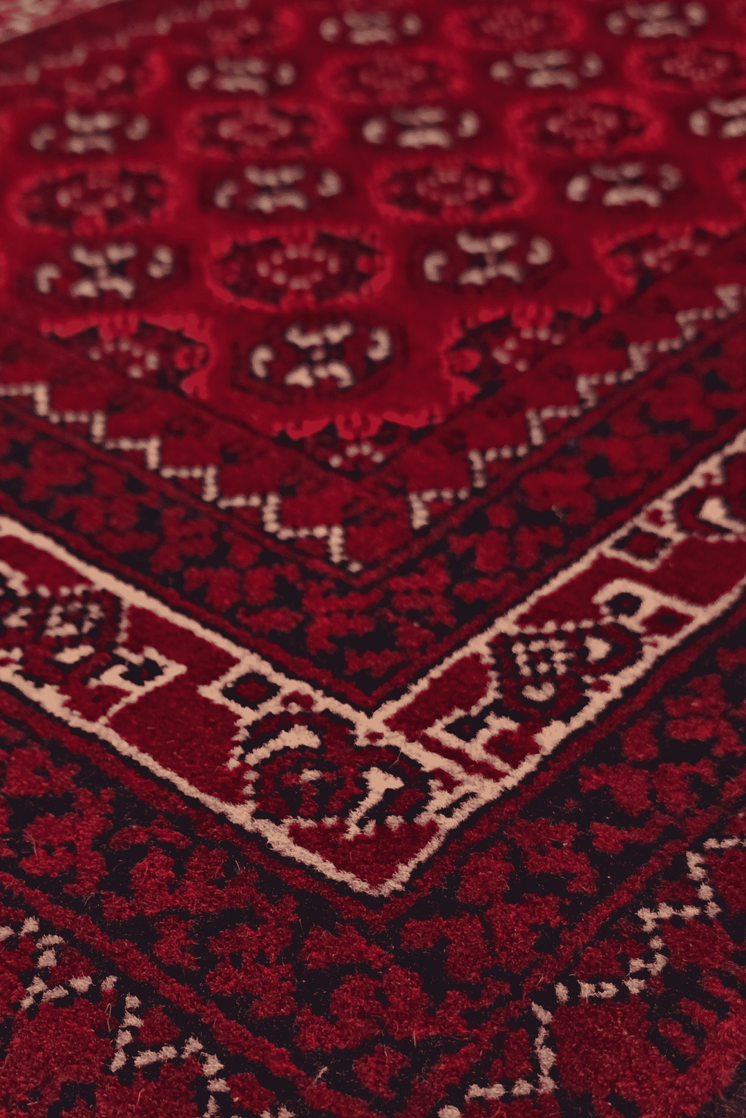 Turkmen gül detail in deep red on small Khal Mohammadi rug