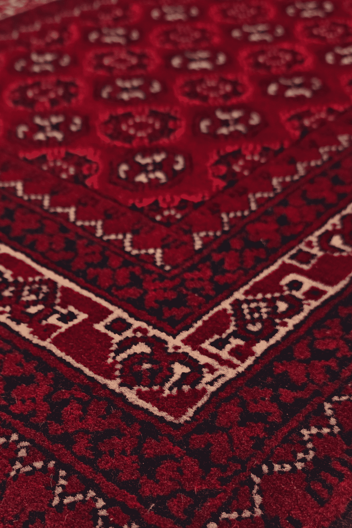 Turkmen gül detail in deep red on small Khal Mohammadi rug