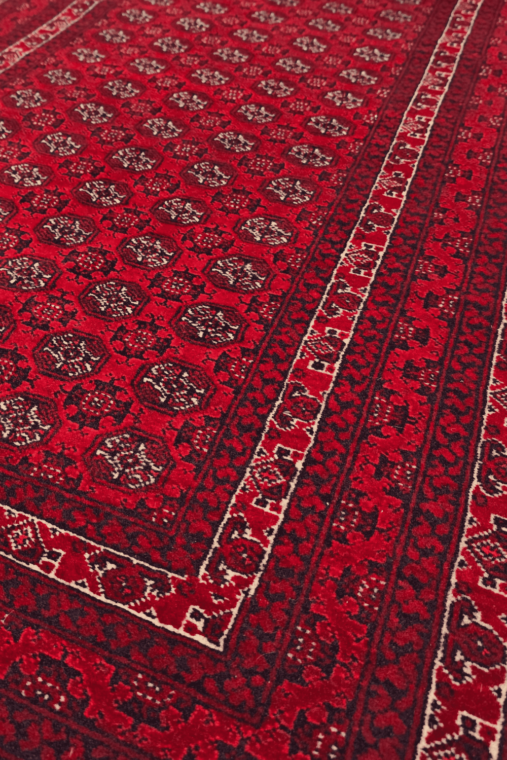 Turkmen gül detail in deep red on small Khal Mohammadi rug