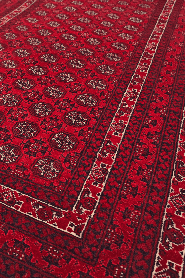 Turkmen gül detail in deep red on small Khal Mohammadi rug