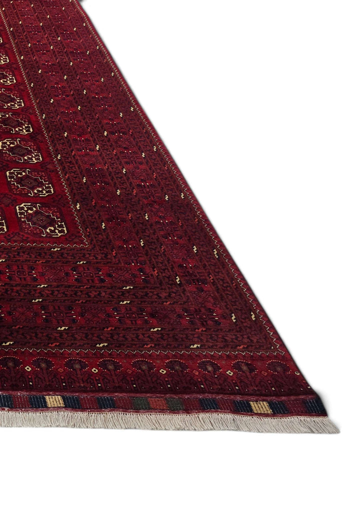 Corner of oxblood Bashiri hand-knotted Afghan rug