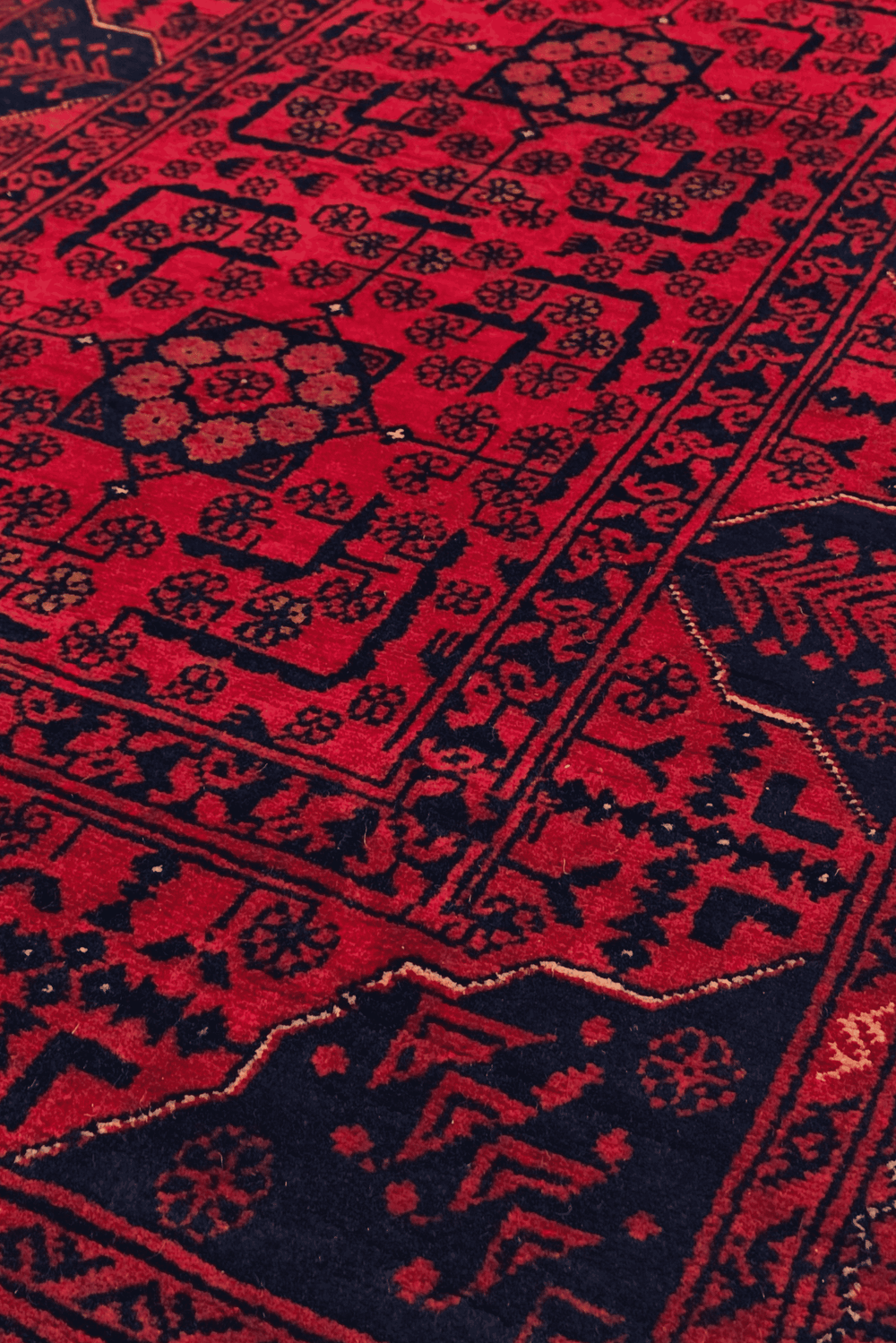 Design detail in raspberry red and navy on Khal Mohammadi runner