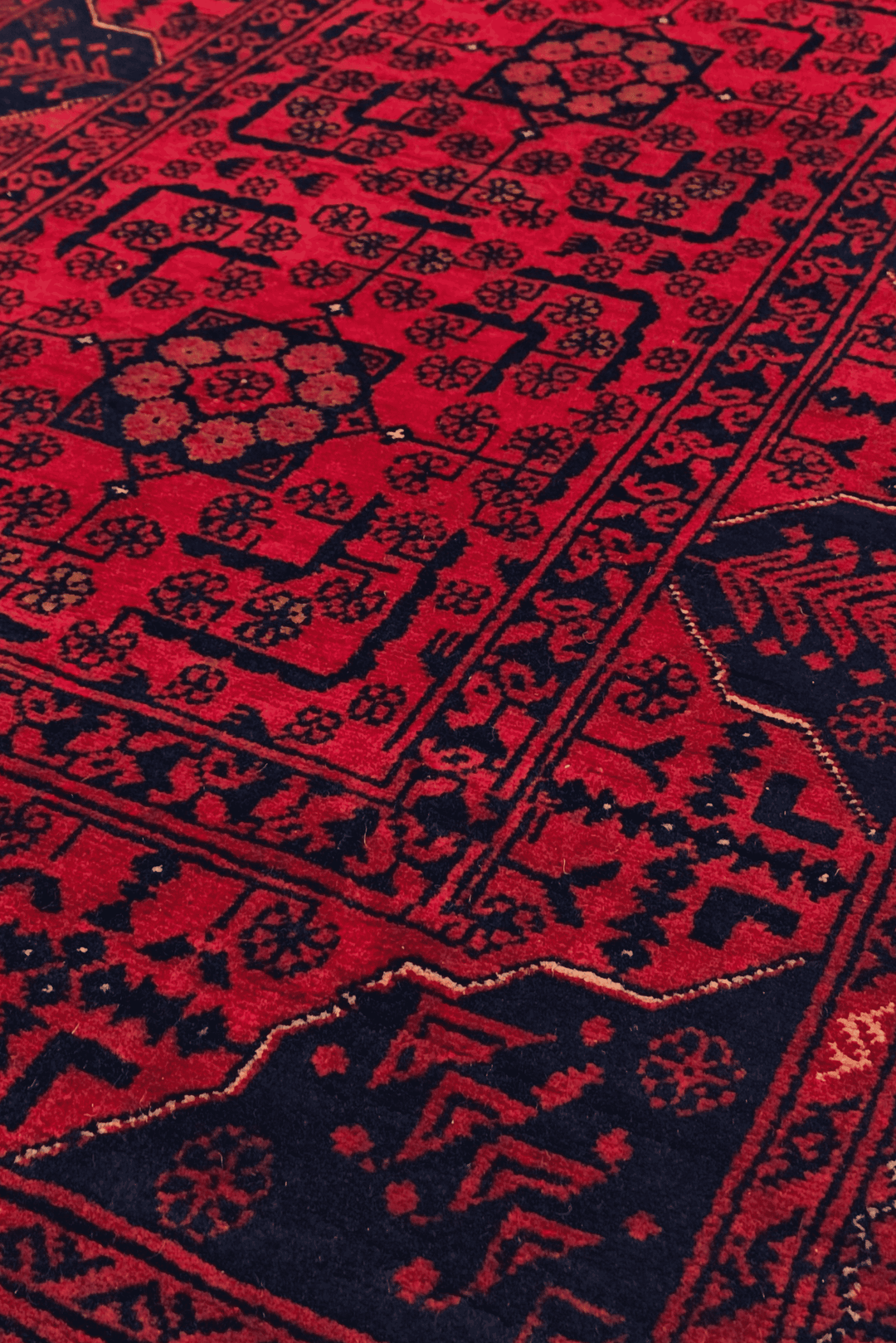 Design detail in raspberry red and navy on Khal Mohammadi runner