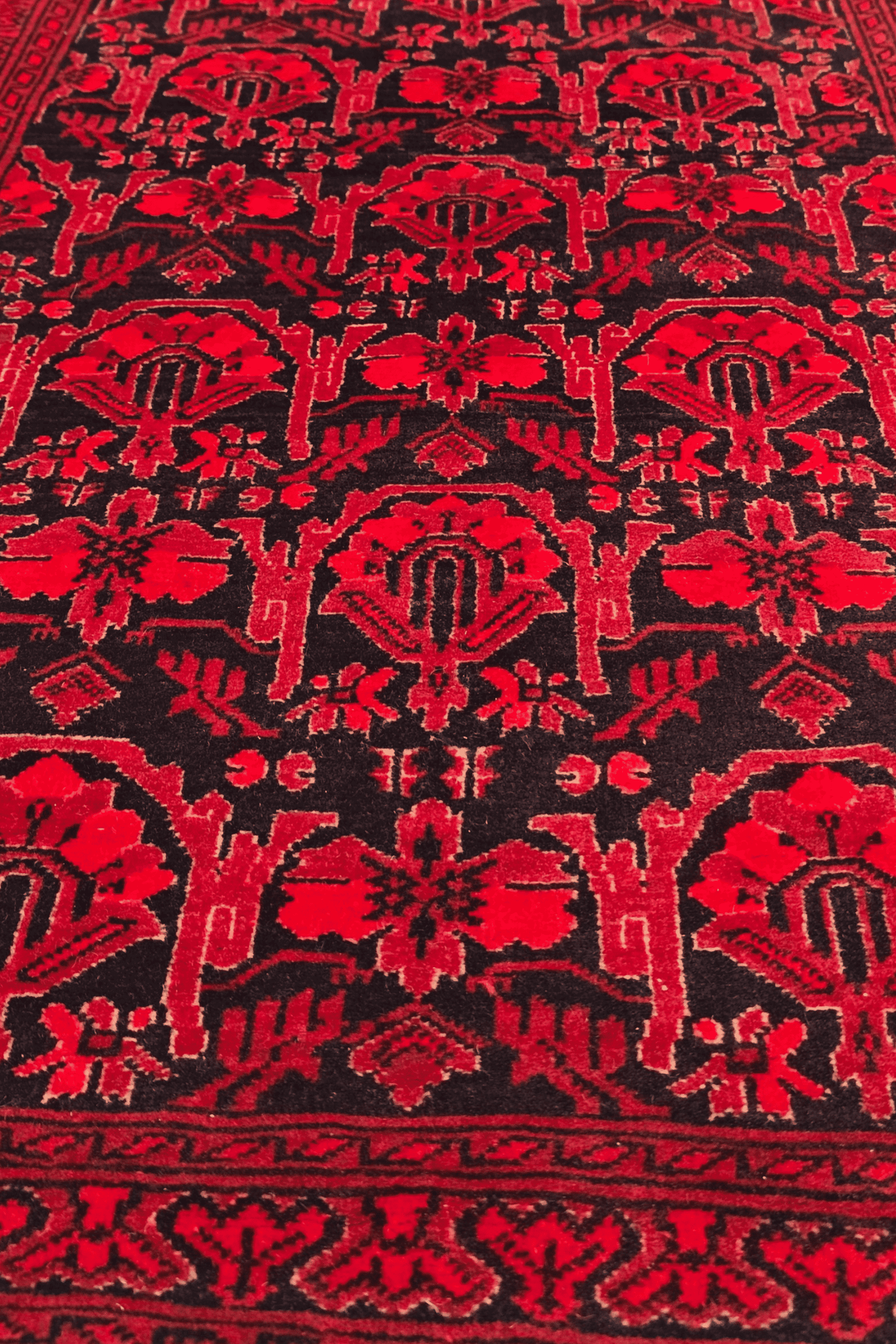 Hand-knotted Khal Mohammadi rug on deep madder red