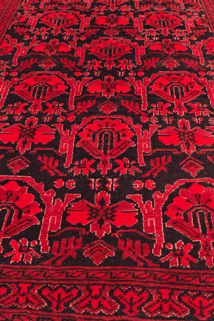 Hand-knotted Khal Mohammadi rug on deep madder red